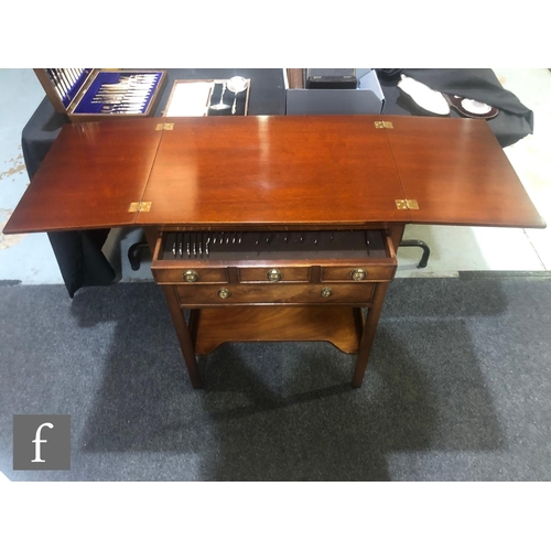 141 - A contemporary Reprodux mahogany canteen table, with hinged fold-over top and three drawers, fitted ... 