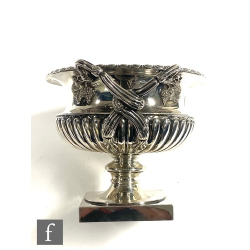 70 - A hallmarked silver pedestal bowl modelled in the manner of The Warwick Vase, square base rising to ... 