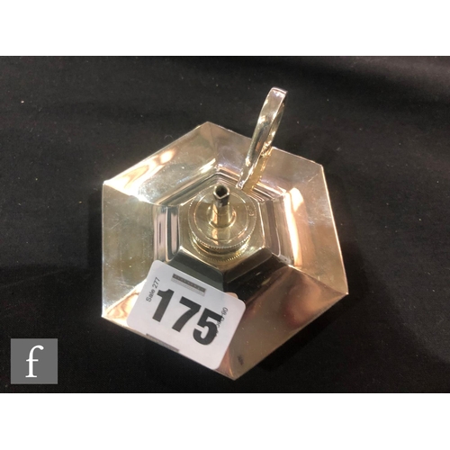 175 - A hallmarked silver hexagonal shaped table lighter with scroll handle and four conforming ashtrays, ... 