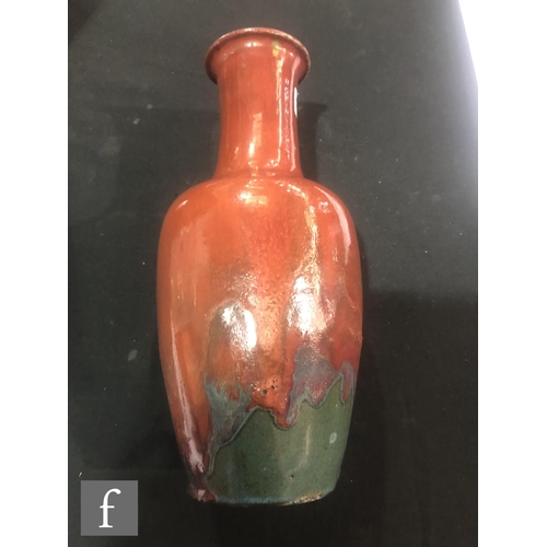 146 - A Chinese flambe glazed bottle vase, the purple and mauve glazes swirling at the base and rising to ... 