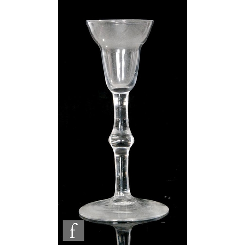 219 - An 18th Century gin glass circa 1740, the pan top bowl above a plain stem with medial knop, raised t... 