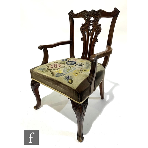 1038 - An early 20th Century Chippendale style mahogany elbow chair, the pierced vase splat below an undula... 