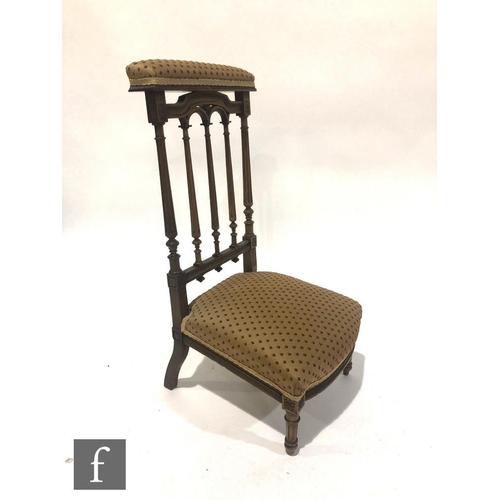 1041 - A Victorian carved walnut prie dieu or prayer chair, the carved fluted back over lozenge pattern sea... 