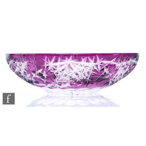 416 - A 20th Century large glass dish of shallow circular form, decorated with amethyst over clear and fla... 