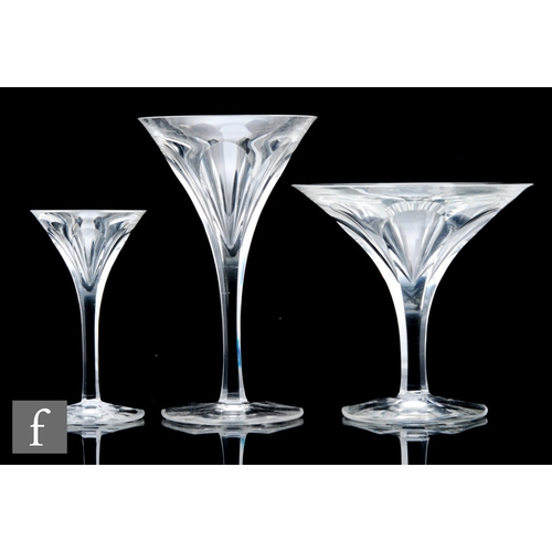 428 - A part suite of clear crystal drinking glasses in the Art Deco style, each with a flared swept bowl ... 