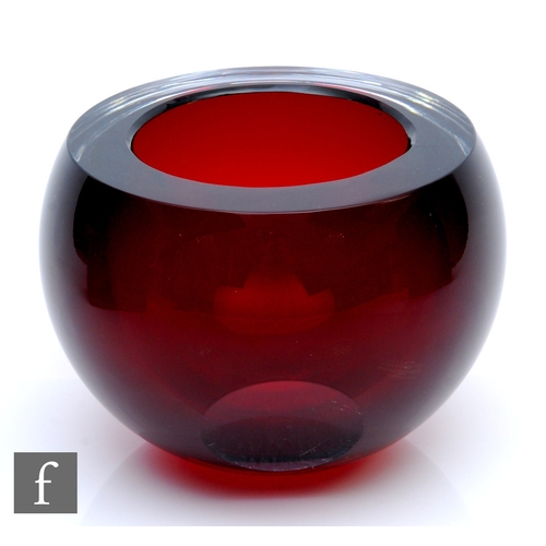 466 - A contemporary studio glass bowl, of spherical form with slice cut rim, internally decorated in ruby... 