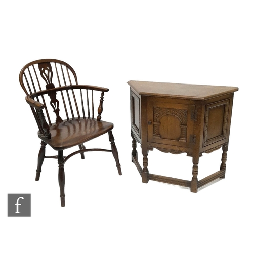 980 - A 19th Century Windsor yew back elbow chair, with elm seat over splayed legs united by a crinoline s... 