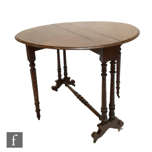 981 - A Victorian mahogany oval drop flap Sutherland table on turned legs united by a turned stretcher, he... 