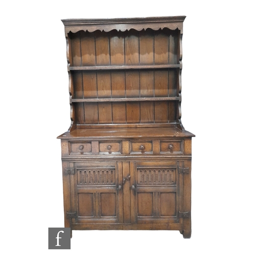 982 - A small 17th Century style oak dresser and rack, fitted two short drawers over a cupboard base, heig... 