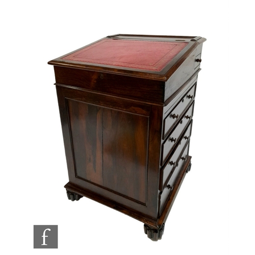 987 - A 19th Century rosewood Davenport in the Gillows style, panelled front and sides below a red leather... 