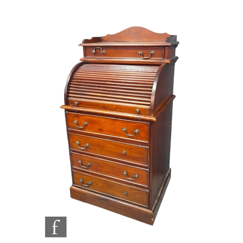 989 - A Victorian style mahogany cylinder desk of small proportions with fitted drawer interior over a tam... 