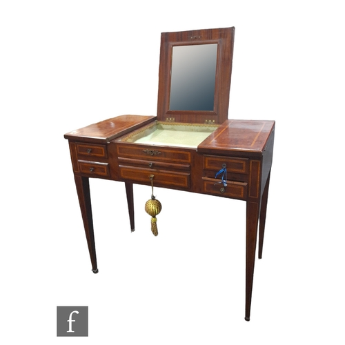 992 - An Edwardian satinwood crossbanded plum pudding mahogany ladies dressing table, the triple hinged to... 