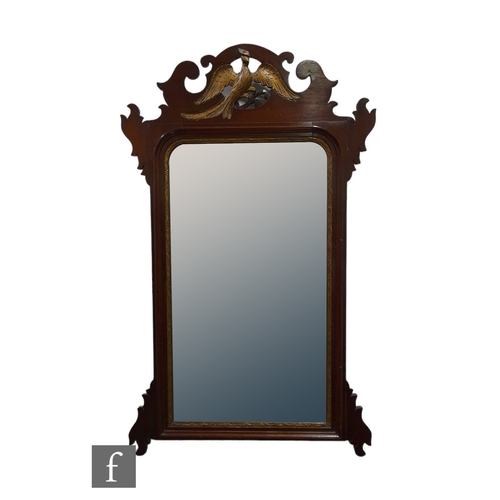 993 - An early 20th Century Chippendale style mahogany and parcel gilt wall mirror, the bevelled edge plat... 