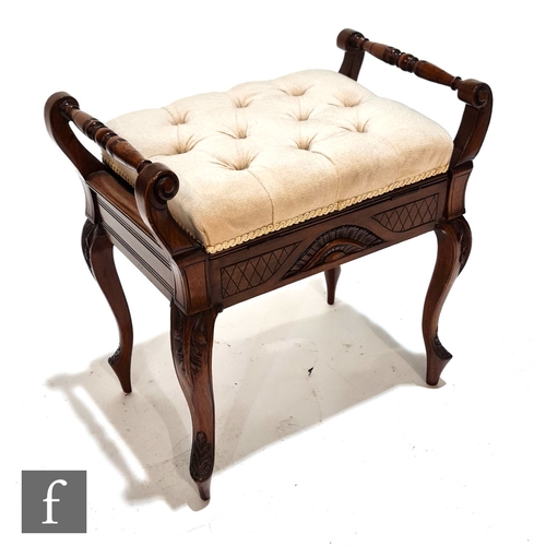 1011 - An Edwardian walnut piano stool of rectangular form, with twin rail sides above the lift-up seat and... 