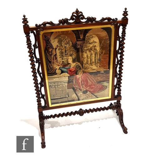 1012 - A large Victorian rosewood framed fire screen with applied scrollwork detail, raised to barleytwist ... 