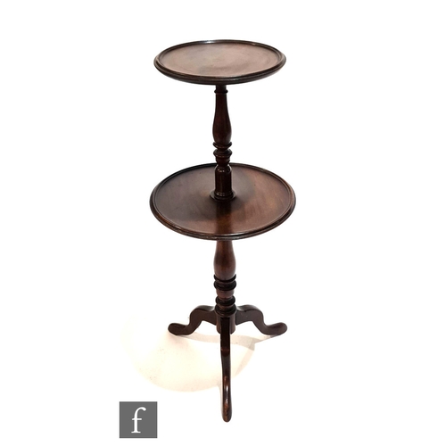 997 - An early 20th Century mahogany two tier dumb waiter, turned baluster pedestal on splayed tripod legs... 