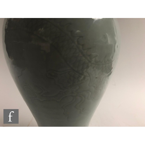 184 - A Chinese Qingbai style meiping vase, the pale blue/grey ground incised with three-clawed dragon in ... 