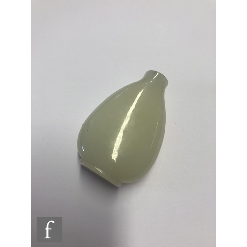 134 - A 19th Century Chinese pale celadon jade snuff bottle, the shallow footring with slopping shoulders,... 