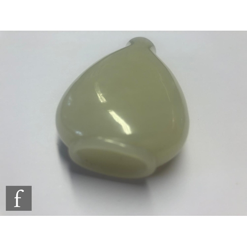 134 - A 19th Century Chinese pale celadon jade snuff bottle, the shallow footring with slopping shoulders,... 