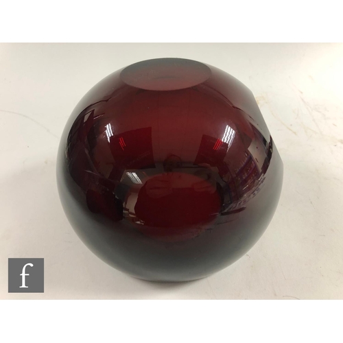 466 - A contemporary studio glass bowl, of spherical form with slice cut rim, internally decorated in ruby... 