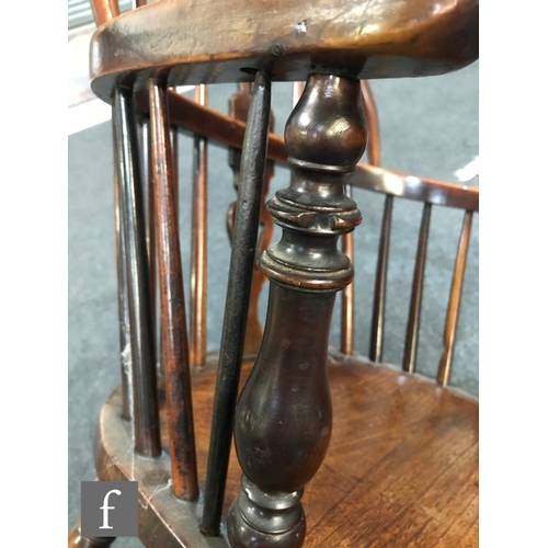 980 - A 19th Century Windsor yew back elbow chair, with elm seat over splayed legs united by a crinoline s... 