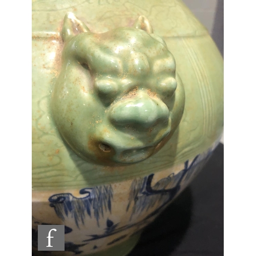 150 - A Chinese celadon glazed vase of tapered ovoid form, the heavily potted body flanked by relief mould... 