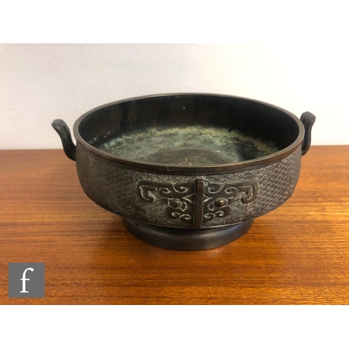 192 - A collection of Asian metalwares, to include a Chinese Archaic style censer, the pedestal vessel wit... 