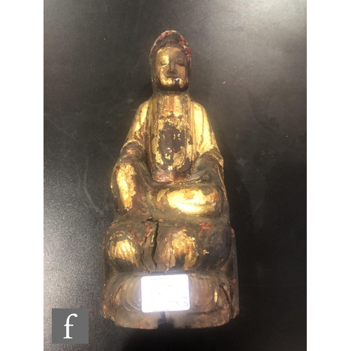 182 - A collection of Asian Buddhistic figures, to include a Chinese glazed figure of Guanyin, height 19.5... 