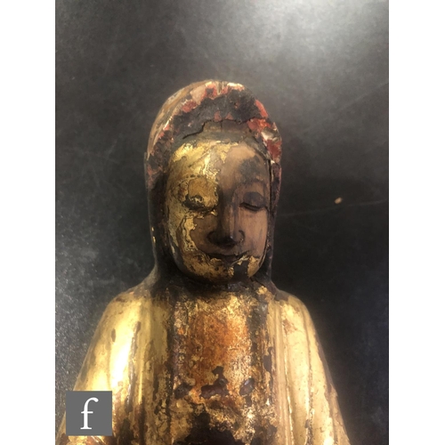 182 - A collection of Asian Buddhistic figures, to include a Chinese glazed figure of Guanyin, height 19.5... 