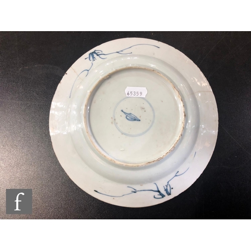 126 - An early 18th Century Chinese blue and white dish of circular form, the cracked ice ground picked ou... 