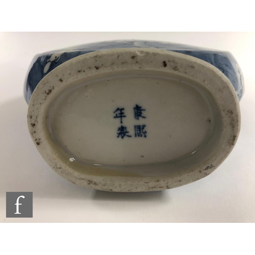 174 - A Chinese 19th Century blue and white 'Prunus' moonflask of rounded form rising from a high footring... 