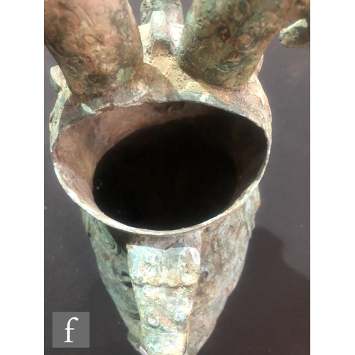 157 - A Chinese archaistic zoomorphic wine vessel (guang), the cast metal vessel raised on tripod supports... 