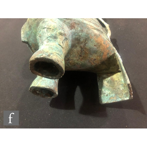 157 - A Chinese archaistic zoomorphic wine vessel (guang), the cast metal vessel raised on tripod supports... 