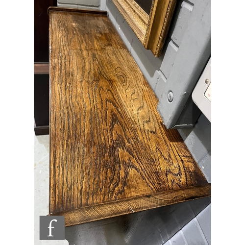 1007 - A pair of oak bookcases in the manner of Minty, each fitted with three glazed double doors over a pl... 