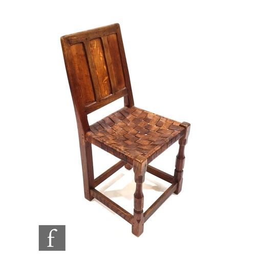 1214 - An Arts and Crafts oak standard or side chair, with fielded panel back over a lattice woven leather ... 