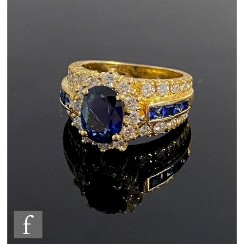 543 - An 18ct sapphire and diamond cluster ring, central oval sapphire within a border of diamonds and fla... 