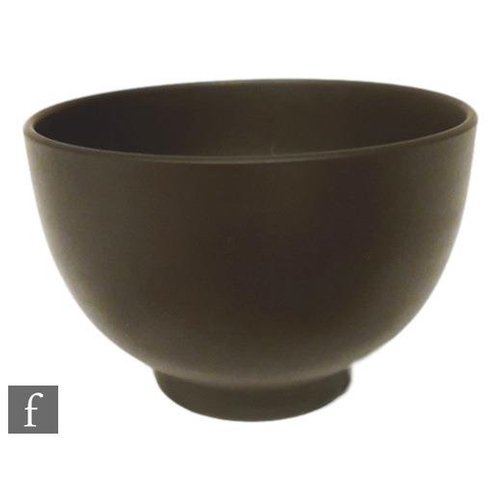 9017 - A small Wedgwood black basalt bowl of footed circular form, in the manner of Keith Murray, impressed... 