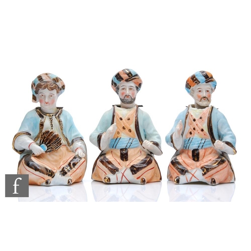 9028 - Three late 19th to early 20th Century bisque nodding figures each modelled as a seated bearded Turki... 