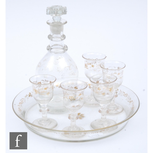 9059 - A late 19th Century continental liquor set comprising circular rimmed tray, five bell bowl glasses w... 