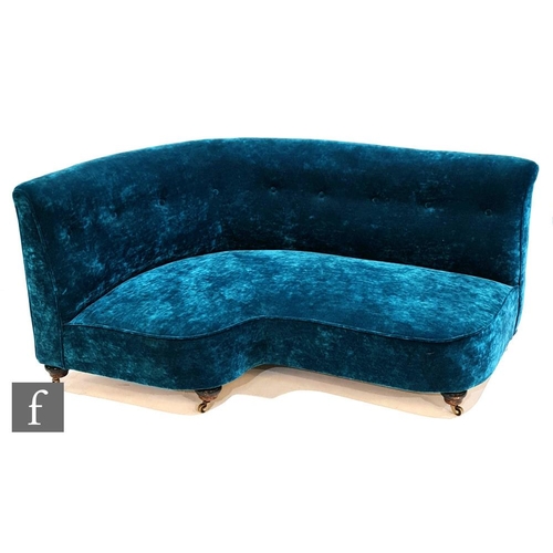 1220 - A late 19th Century corner sofa by Howard and Sons, later upholstered in teal blue velvet, raised to... 