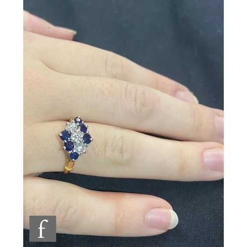 438 - An 18ct hallmarked sapphire and diamond nine stone ring, off set alternating rows of three claw set ... 