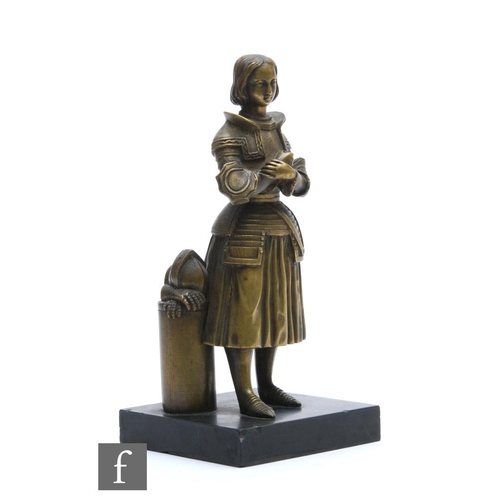 467 - A 19th Century gilt metal figure of Joan of Arc standing with folded hands near her helmet and a pai... 