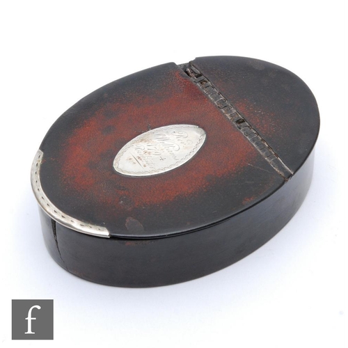 469 - A late 18th Century oval papier mache snuff box, the hinged cover inset with a silver engraved panel... 