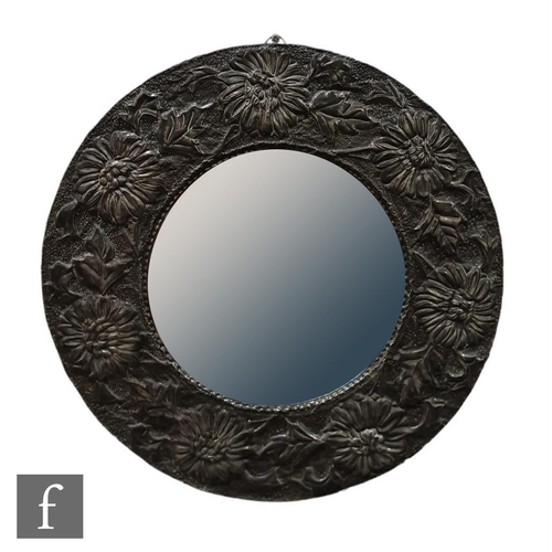 42 - Unknown - An Arts & Crafts pewter convex wall mirror, the central domed mirror plate encircled w... 