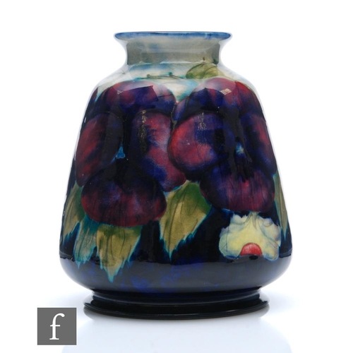 182 - William Moorcroft - A vase of flared barrel form decorated in the Pansy pattern with a wide band of ... 