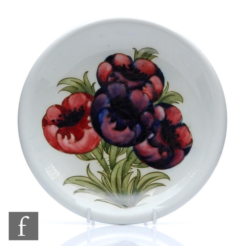 184 - William Moorcroft - A shallow plate with a flared rim decorated in the Big Poppy (or Anemone) with f... 