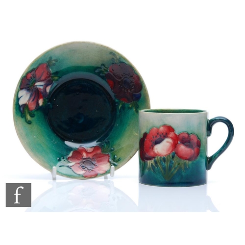 186 - William Moorcroft - A coffee cup and saucer decorated in the Anemone pattern, Moorcroft Museum label... 