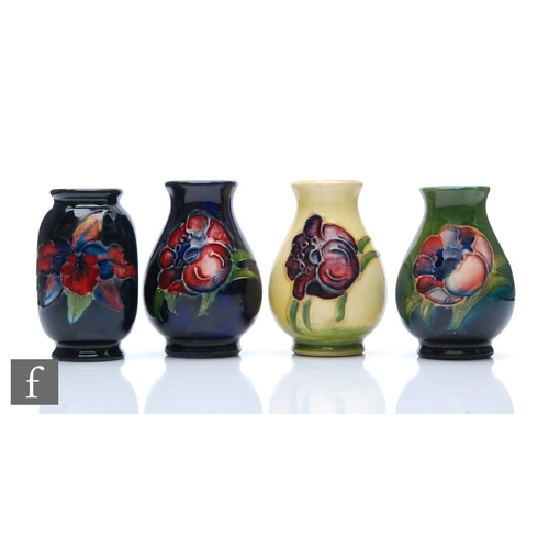 260 - Walter Moorcroft - Moorcroft Pottery - Four miniature vases of varying form comprising three Anemone... 