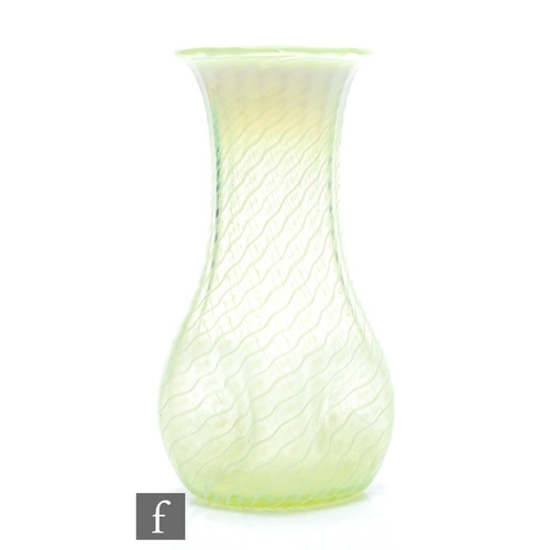 38 - In the manner of James Powell & Sons - An early 20th Century straw opal glass vase with quatrelo... 