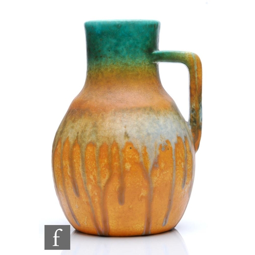 120 - Ruskin Pottery - A crystalline glaze flower jug decorated in bands of green to orange to pale blue t... 